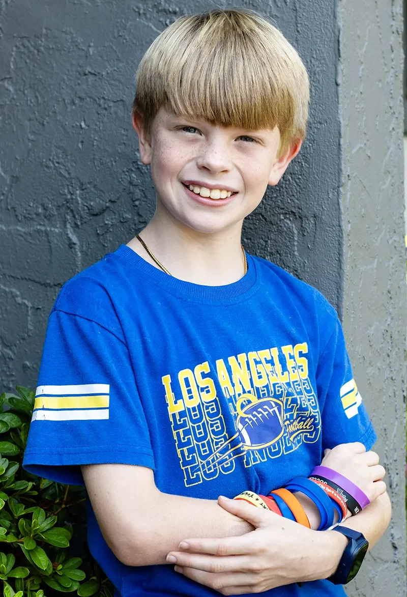 young boy in blue t-shirt smiling